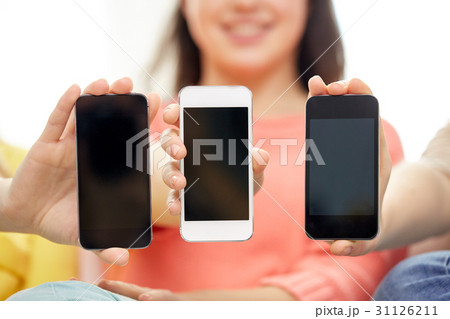 happy women or teenage girls with smartphones 31126211