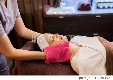 woman having face massage with terry gloves at spa 31126352