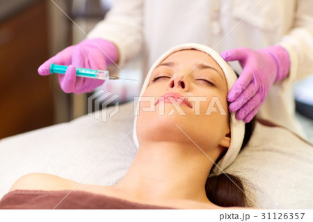 beautician doing beauty injection to woman lips beautician doing beauty injection to woman lips 31126357