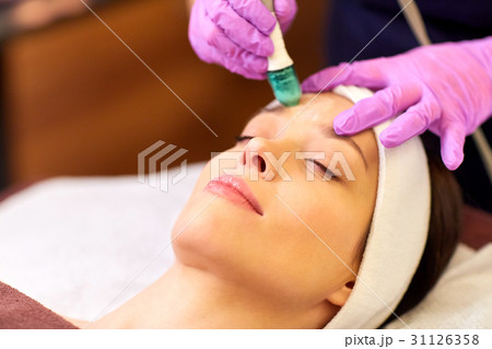 woman having microdermabrasion facial treatment 31126358
