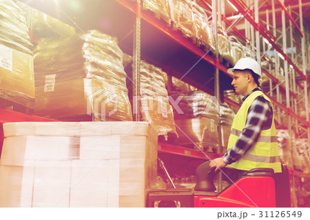 man on forklift loading cargo at warehouse man on forklift loading cargo at warehouse 31126549