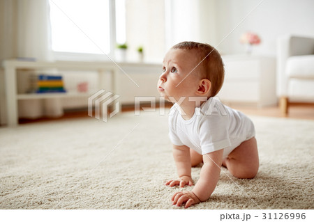 little baby in diaper crawling on floor at home 31126996