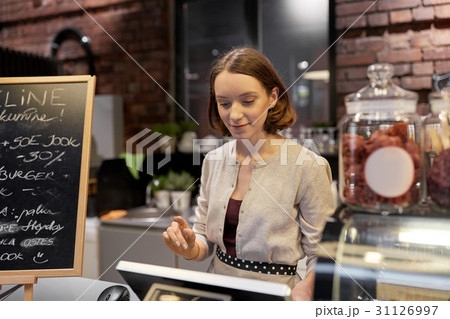 happy woman or barmaid with cashbox at cafe 31126997