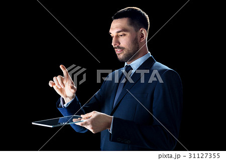 businessman in suit with transparent tablet pc businessman in suit with transparent tablet pc 31127355