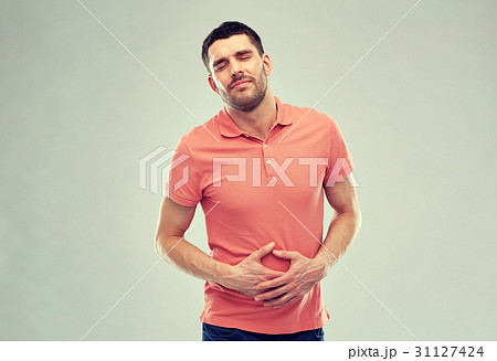 unhappy man suffering from stomach ache unhappy man suffering from stomach ache 31127424