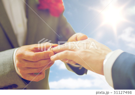 close up of male gay couple hands and wedding ring 31127498