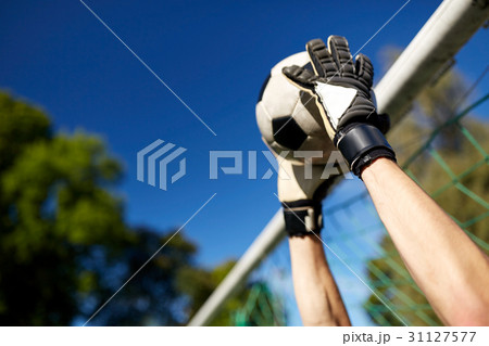 goalkeeper with ball at football goal on field 31127577