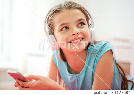 close up of girl with smartphone and headphones close up of girl with smartphone and headphones 31127604