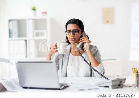 businesswoman calling on phone at office 31127637