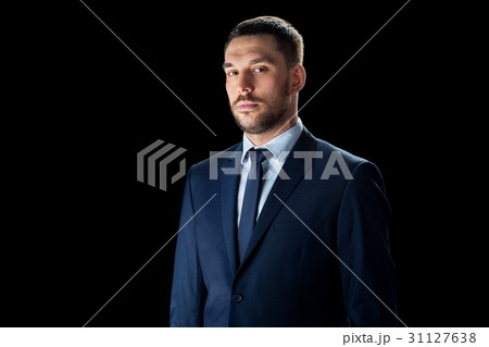 buisnessman in suit over black 31127638