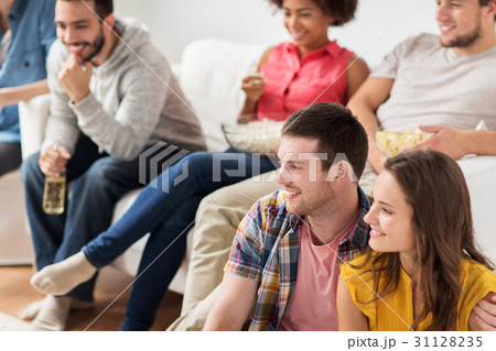 happy friends watching tv at home happy friends watching tv at home 31128235