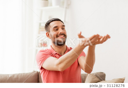 happy man holding something imaginary at home happy man holding something imaginary at home 31128276