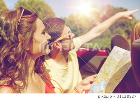 happy friends with map driving in cabriolet car happy friends with map driving in cabriolet car 31128527