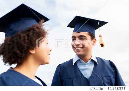 happy students or bachelors in mortarboards 31128573