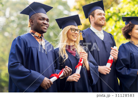 happy students in mortar boards with diplomas happy students in mortar boards with diplomas 31128583