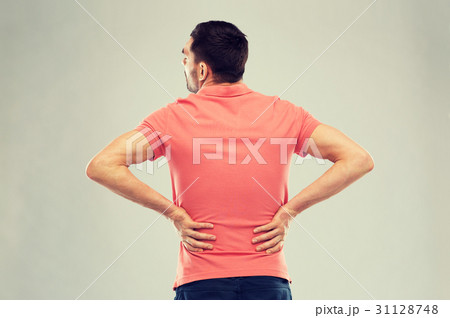 unhappy man suffering from backache at home 31128748