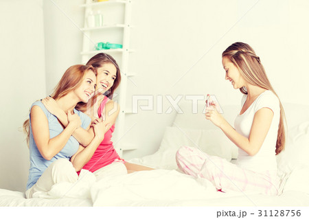 teen girls with smartphone taking picture at home teen girls with smartphone taking picture at home 31128756