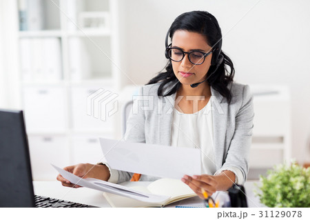 businesswoman with headset and computer at office businesswoman with headset and computer at office 31129078
