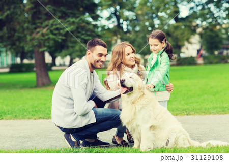 happy family with labrador retriever dog in park 31129108