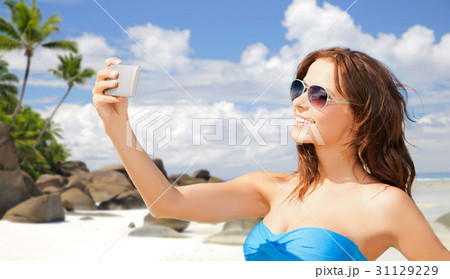 woman in swimsuit taking selfie with smatphone 31129229