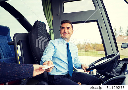 bus driver taking ticket or card from passenger 31129233