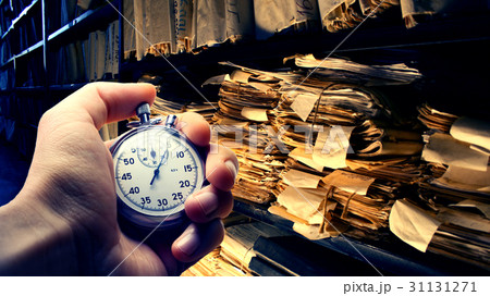 Hand holding stopwatch on budget numbers 31131271