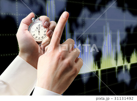 Candlestick chart graphic and stopwatch in hand 31131492