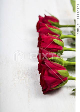 Red roses on a wooden background. Red roses on a wooden background. 31132371