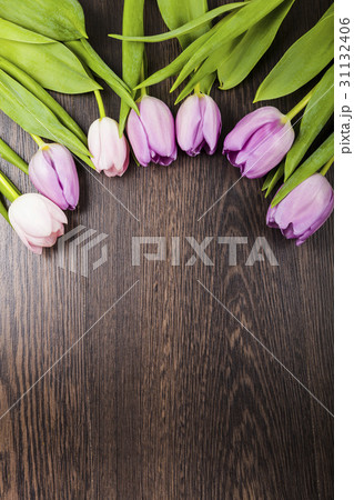 Bouquet of tulips on a wooden background. Bouquet of tulips on a wooden background. 31132406