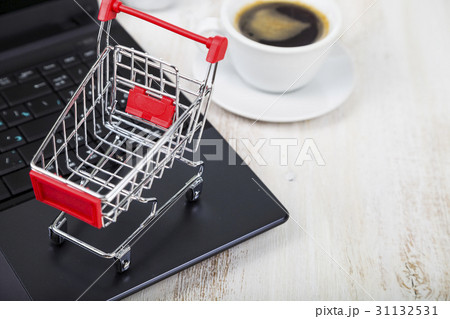 Shopping basket, laptop and cup of coffee Shopping basket, laptop and cup of coffee 31132531