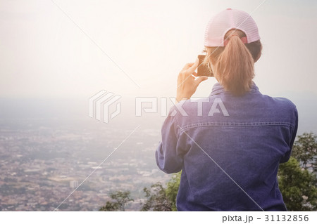 Traveling women are using a smartphone to capture 31132856