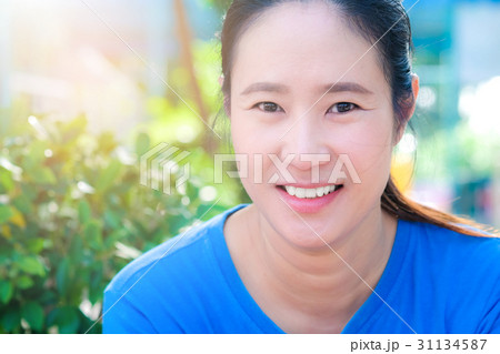 Asian woman smiling bright happy in a park Asian woman smiling bright happy in a park 31134587