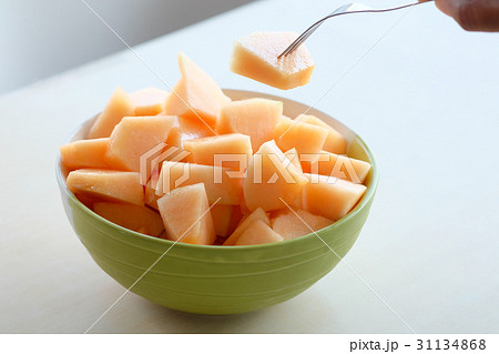 hands using the fork to melt the orange meat hands using the fork to melt the orange meat 31134868
