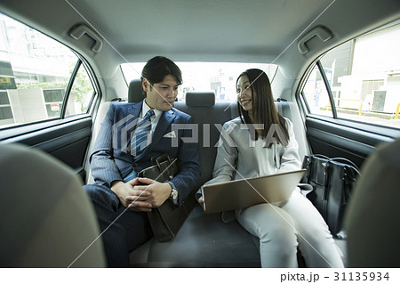 President And Secretary Sitting In The Back Seat Stock Photo