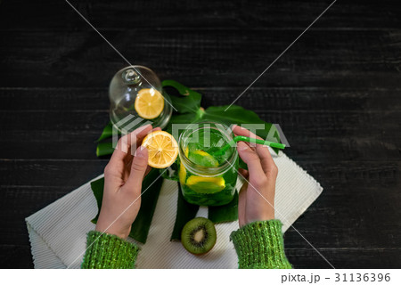 Drink with fresh lemon,kiwi, orangefrom bottle  31136396