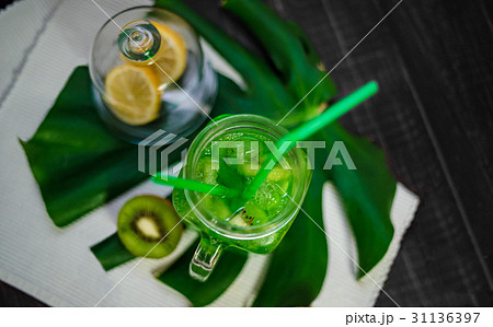 Drink with fresh lemon,kiwi, orangefrom bottle Drink with fresh lemon,kiwi, orangefrom bottle 31136397