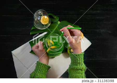 Drink with fresh lemon,kiwi, orangefrom bottle  31136398