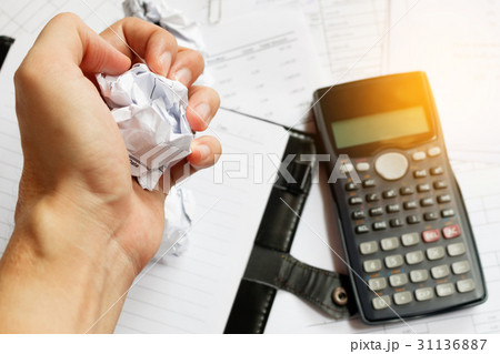 Businessman sitting at desk in a little office Businessman sitting at desk in a little office 31136887