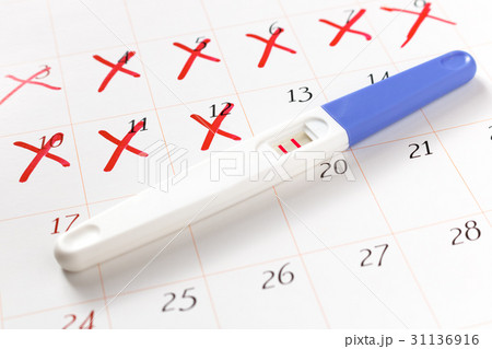 Pregnancy test with positive result on calendar 31136916