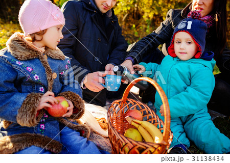 Happy young family of four having picnic 31138434