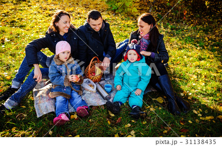 Happy young family of four having picnic Happy young family of four having picnic 31138435