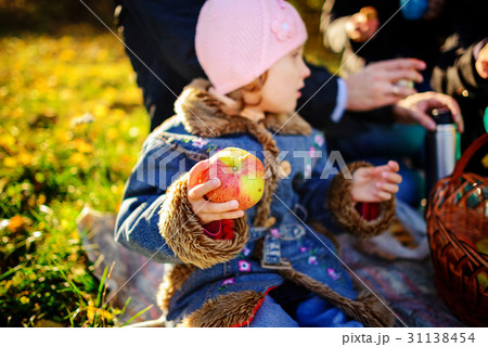 Girl sitting on the grass with an apple  31138454