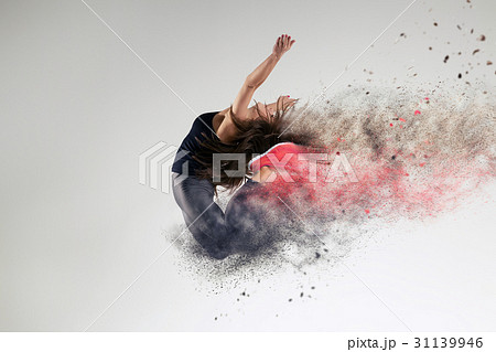 Woman In Jump In Studio And Disintegration Effectの写真素材