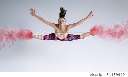 Woman in jump in studio and disintegration effect 31139949