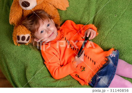 little girl lying on a big green pillow little girl lying on a big green pillow 31140856