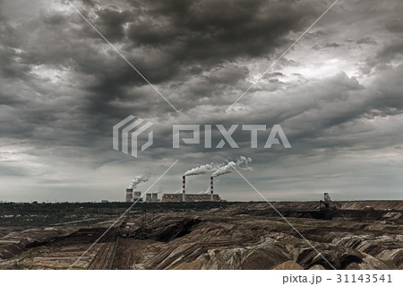 Storm clouds over open pit mine and power plant. 31143541