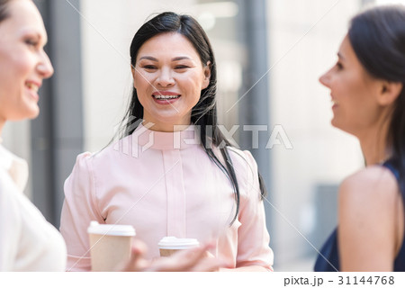 Beaming woman speaking with affiliates Beaming woman speaking with affiliates 31144768