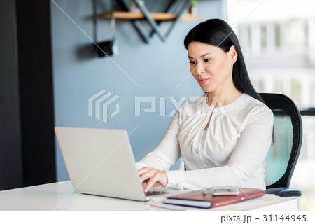 Elegant young lady working on notebook Elegant young lady working on notebook 31144945