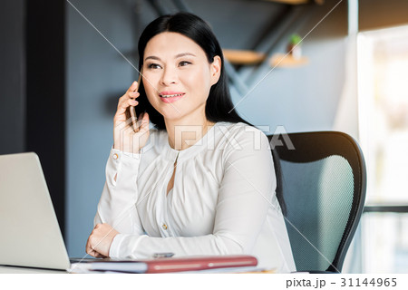Cheerful attractive young lady working in office Cheerful attractive young lady working in office 31144965