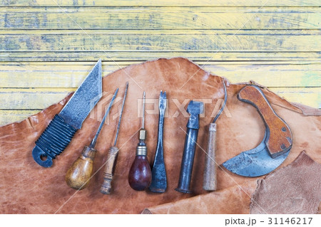 Leather craft tools on a wooden background 31146217